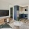a living room with a tv and couches
