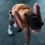 a person bending over and holding a bottle